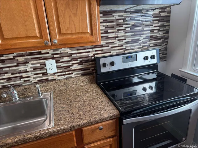 a stove top oven sitting inside of a kitchen