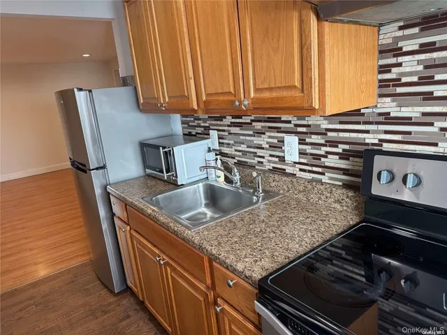 a kitchen with stainless steel appliances granite countertop a sink and a stove