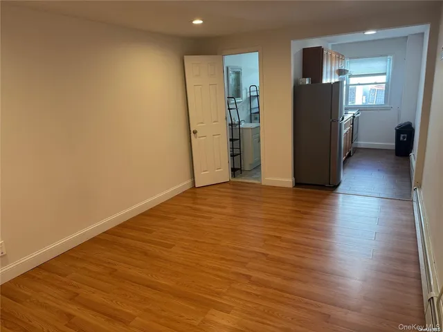 a view of a livingroom with wooden floor and stairs