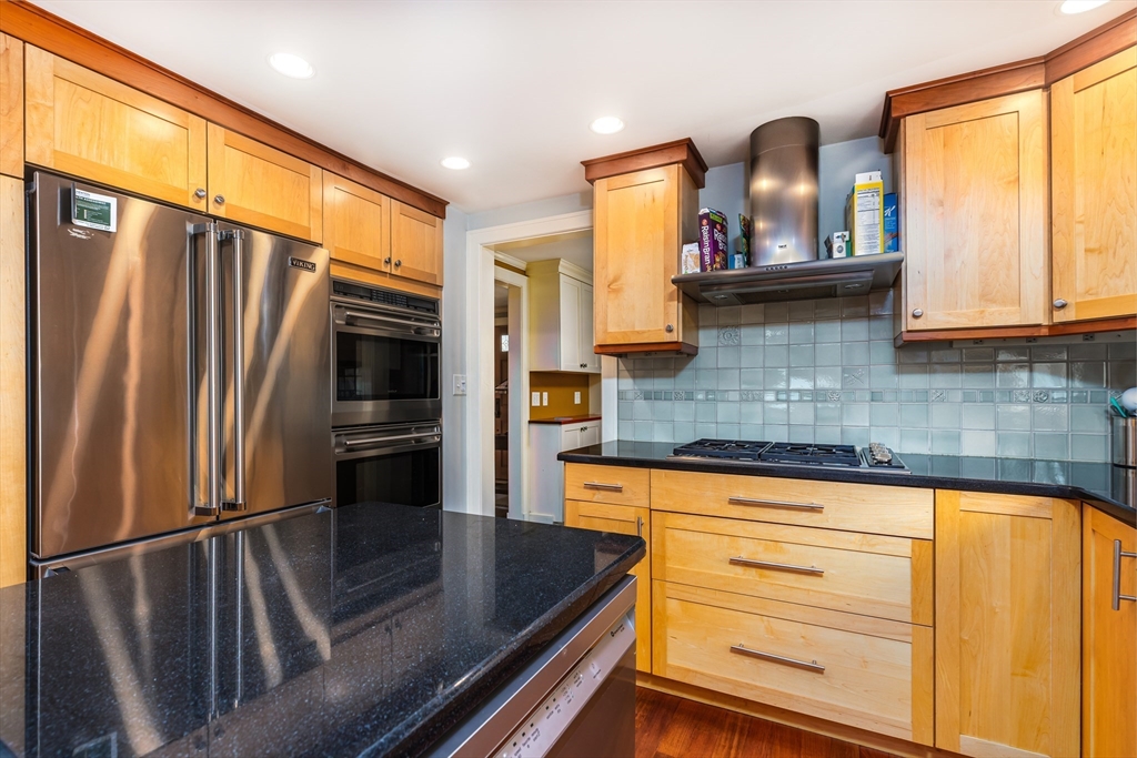 17 Deforest Road Newton, MA 02462 - Photo 9 of 31 a kitchen with stainless steel appliances granite countertop a refrigerator a stove and a sink with cabinets
