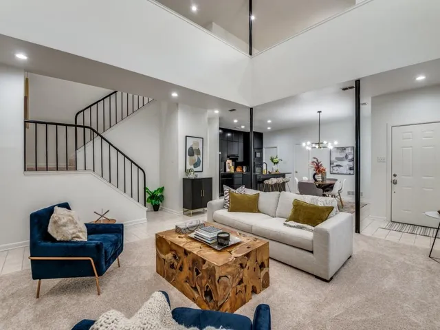 a living room with furniture ceiling fan and a rug