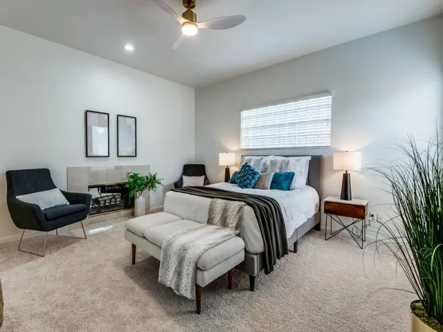 a bedroom with furniture and a large window