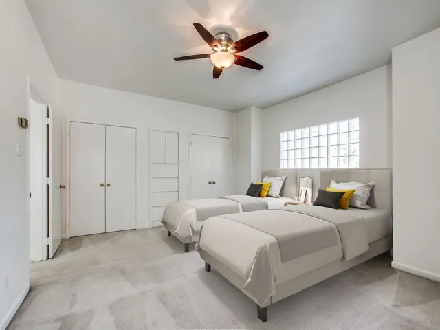 a bedroom with bed and window