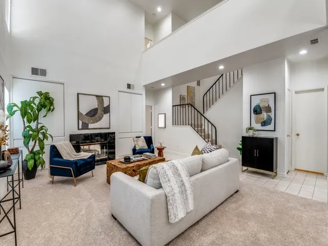 a living room with furniture and a potted plant