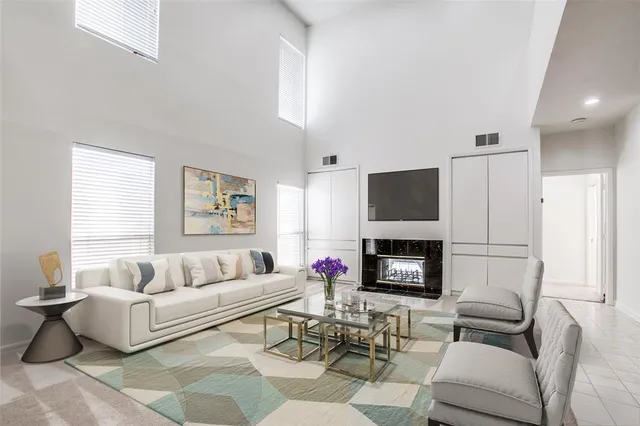 a living room with fireplace furniture and a flat screen tv