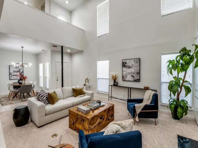 a living room with furniture potted plant and a window