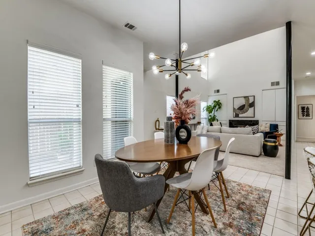 a dining room with furniture a window and a chandelier