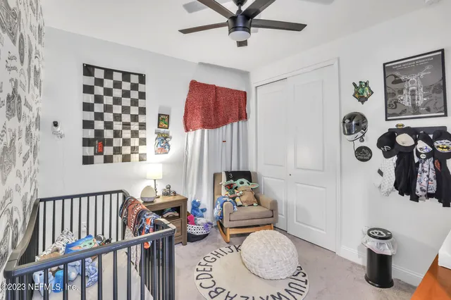 a living room with furniture and paintings on the wall