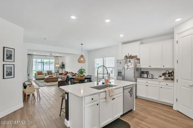 a view of a kitchen with center island and stainless steel appliances