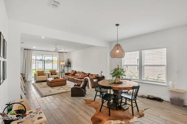 a living room with furniture a window and a dining table