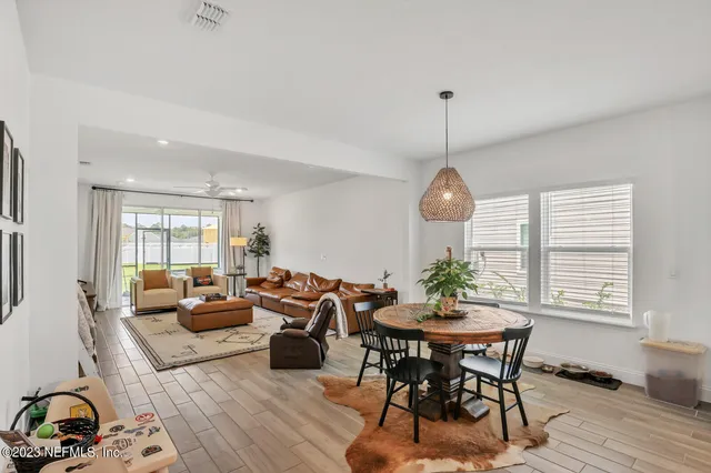 a living room with furniture a window and a dining table