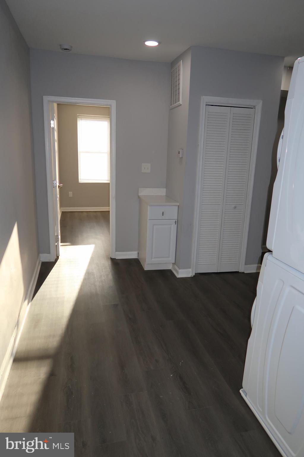 2833 Brendan Avenue, Unit 2 Baltimore, MD 21213 - Photo 12 of 17 a view of a hallway with wooden floor and cabinet