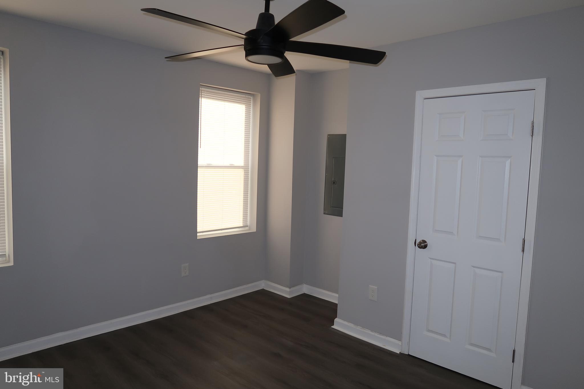 2833 Brendan Avenue, Unit 2 Baltimore, MD 21213 - Photo 16 of 17 an empty room with wooden floor closet and windows