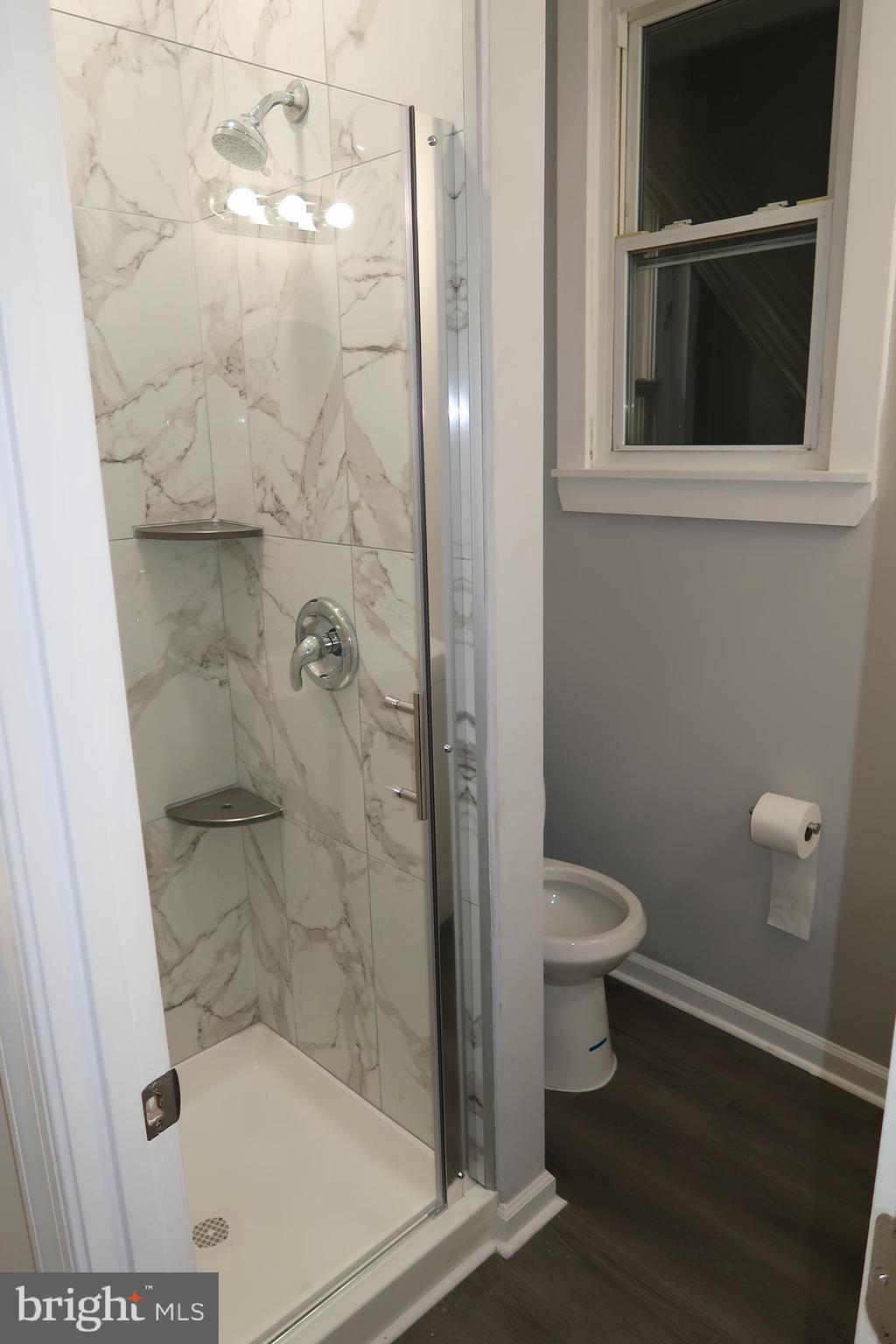 2833 Brendan Avenue, Unit 2 Baltimore, MD 21213 - Photo 9 of 17 a bathroom with a toilet and a shower