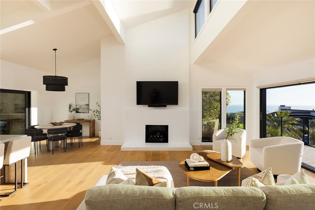 630 Loretta Drive Laguna Beach, CA 92651 - Photo 12 of 75 a living room with furniture a fireplace and a flat screen tv