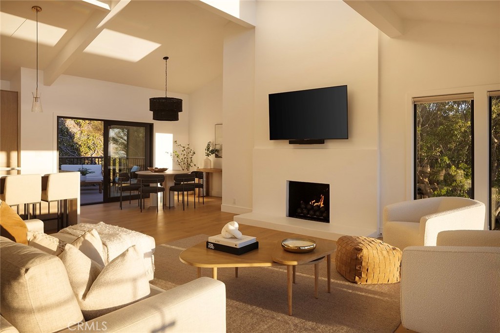 630 Loretta Drive Laguna Beach, CA 92651 - Photo 14 of 75 a living room with furniture a flat screen tv and a fireplace