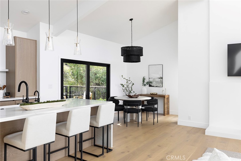 630 Loretta Drive Laguna Beach, CA 92651 - Photo 18 of 75 a view of a dining room and a kitchen with a table chairs
