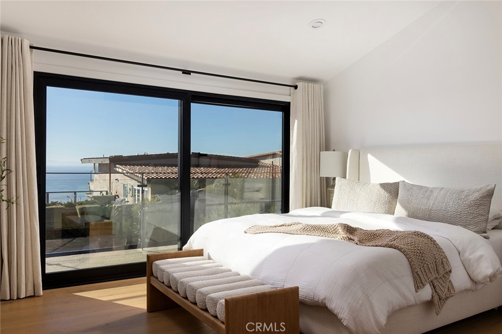 630 Loretta Drive Laguna Beach, CA 92651 - Photo 30 of 75 a bedroom with a bed and wooden floor