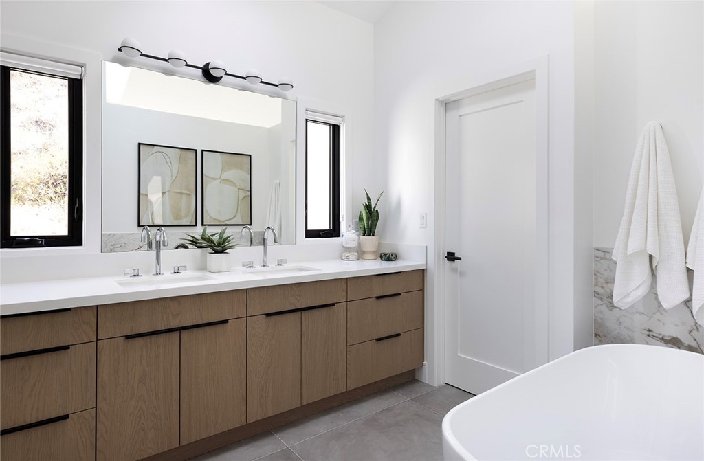 630 Loretta Drive Laguna Beach, CA 92651 - Photo 35 of 75 a bathroom with a sink and a mirror