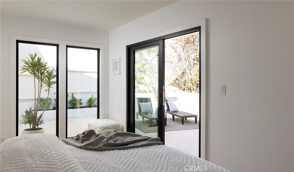 630 Loretta Drive Laguna Beach, CA 92651 - Photo 42 of 75 a bedroom with a large bed and a large window with outer view