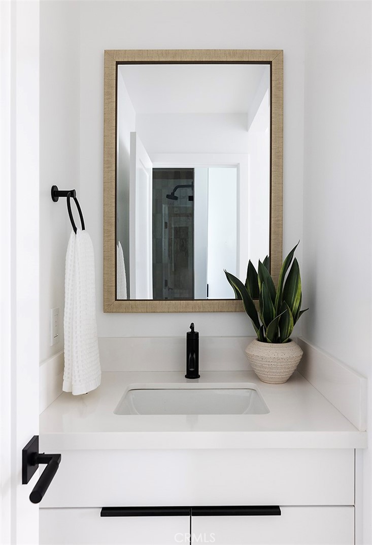 630 Loretta Drive Laguna Beach, CA 92651 - Photo 44 of 75 a bathroom with a sink a mirror and potted plant