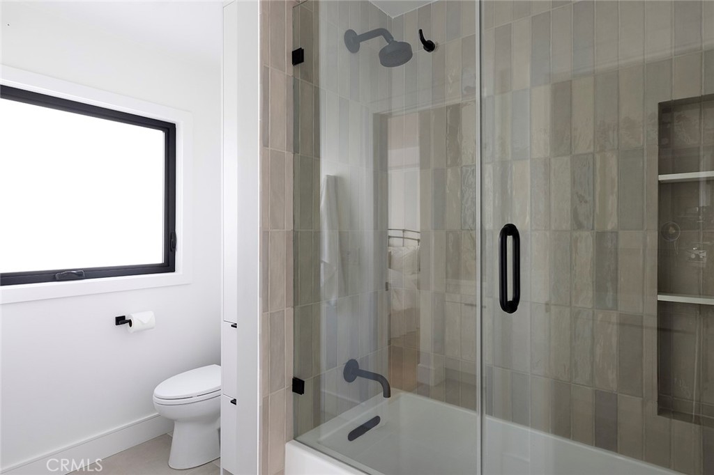 630 Loretta Drive Laguna Beach, CA 92651 - Photo 48 of 75 a bathroom with a granite countertop toilet a sink and shower