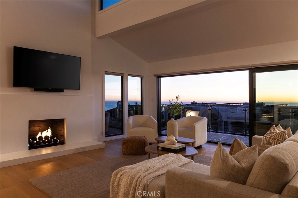 630 Loretta Drive Laguna Beach, CA 92651 - Photo 55 of 75 a living room with furniture a fireplace and a flat screen tv