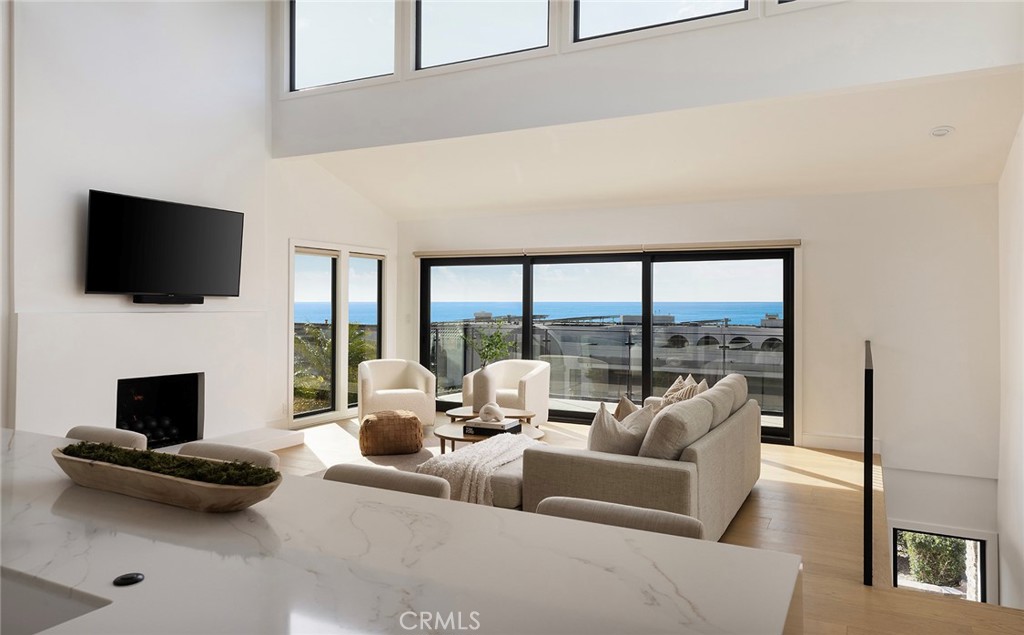 630 Loretta Drive Laguna Beach, CA 92651 - Photo 7 of 75 a living room with furniture a fireplace and a flat screen tv