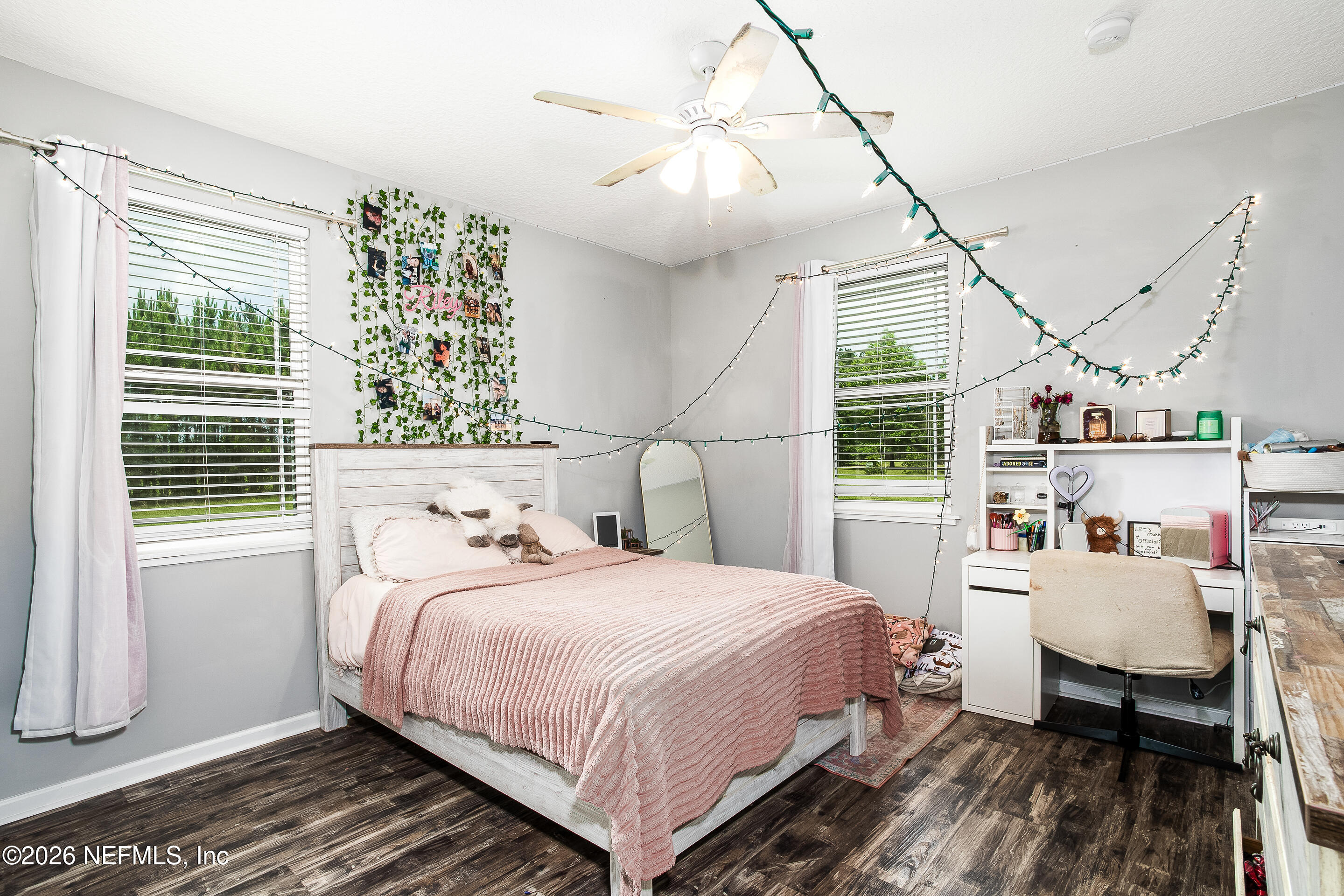 26575 Sheared Stokes Road Hilliard, FL 32046 - Photo 12 of 39 a bedroom with a bed a large window and book self