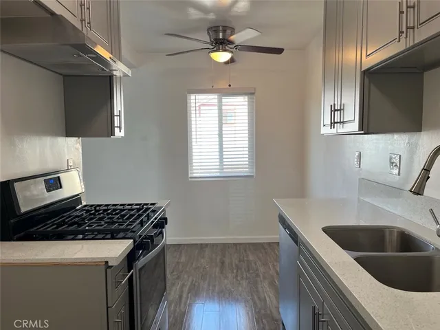 a kitchen that has a sink and a stove in it