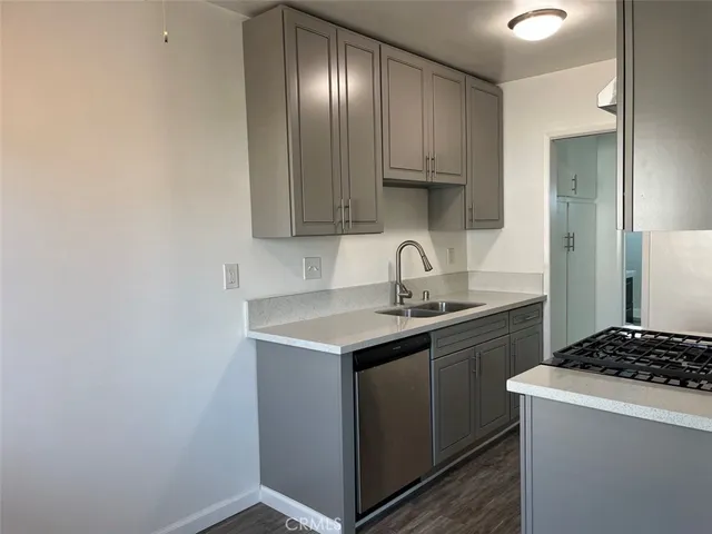 a kitchen with a sink cabinets and stainless steel appliances