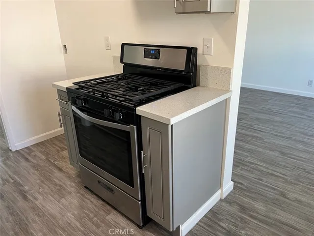 a stove top oven sitting inside of a kitchen