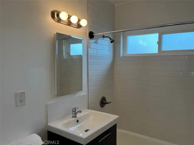 a bathroom with a sink a mirror and a shower