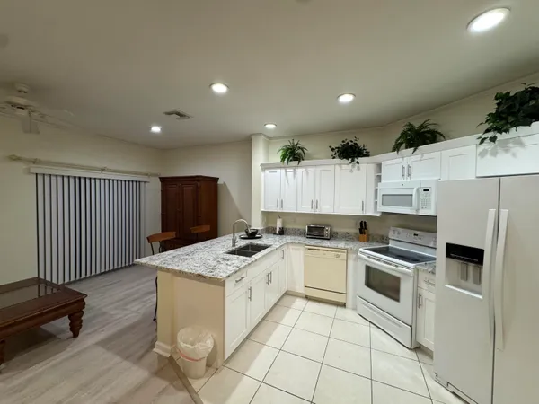 a kitchen with a stove a sink and a refrigerator