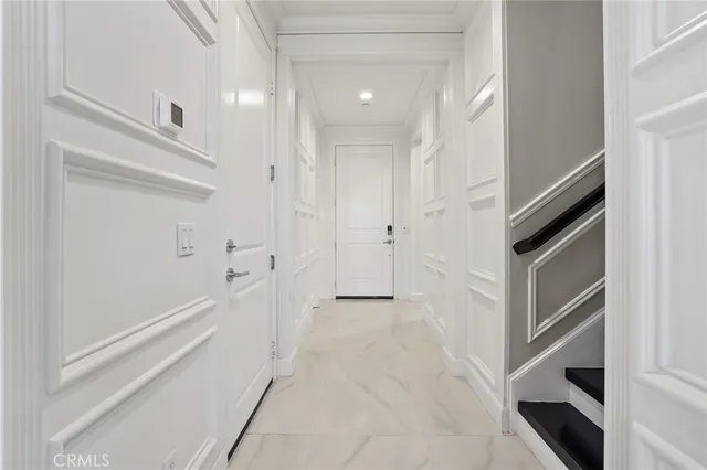 a view of a hallway with entryway and stairs