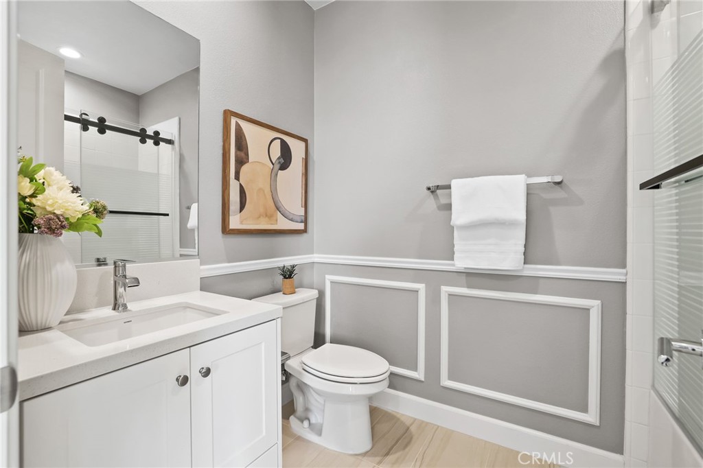 1213 Providence Loop Placentia, CA 92870 - Photo 18 of 43 a bathroom with a toilet sink vanity and mirror