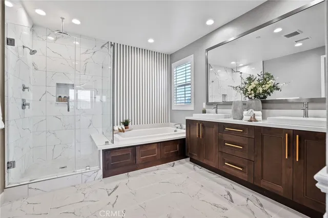 a bathroom with a double vanity sink mirror and shower