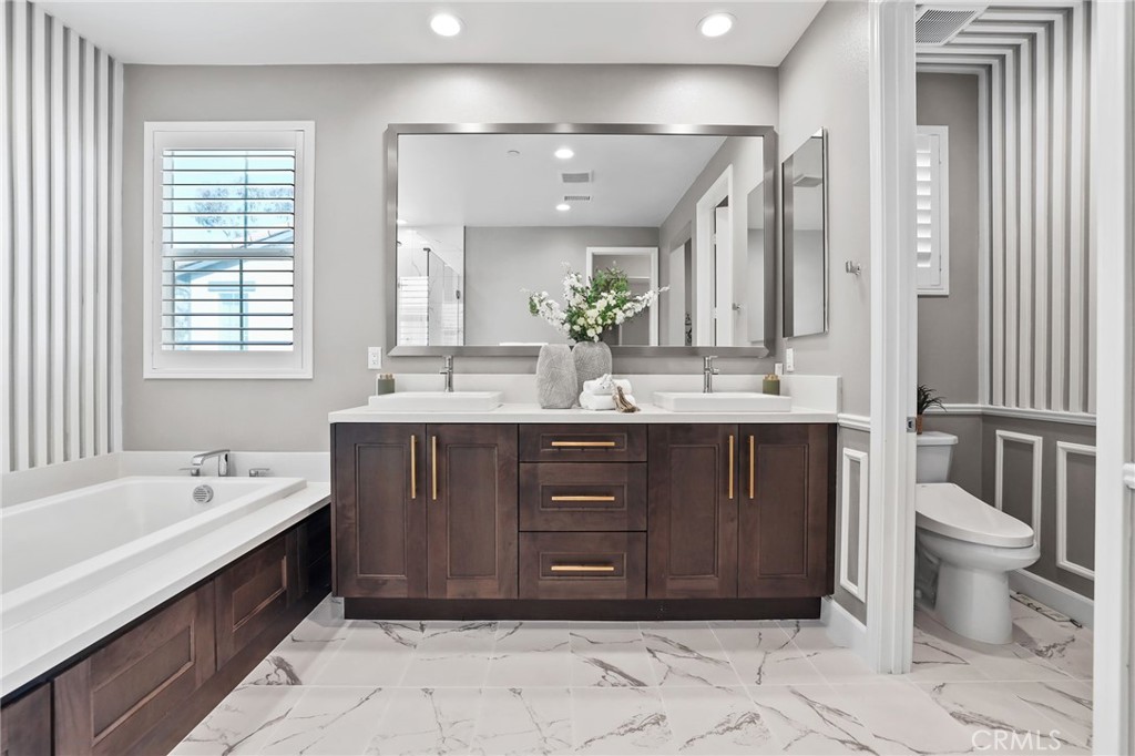 1213 Providence Loop Placentia, CA 92870 - Photo 28 of 43 a bathroom with a tub sink and mirror