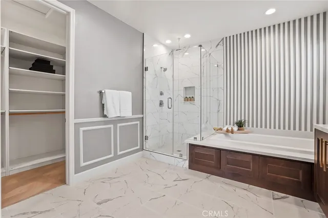 a spacious bathroom with a double vanity sink a mirror and a bathtub