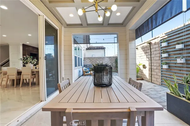 a view of a dining room with furniture a chandelier and wooden floor
