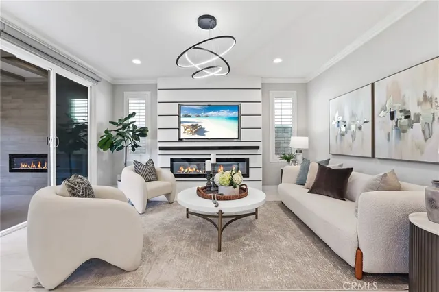a living room with furniture a fireplace and a large window