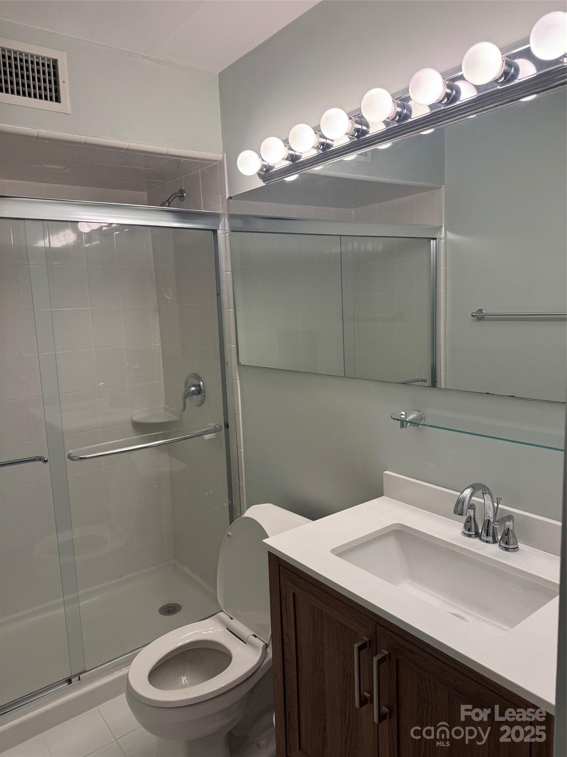 400 Queens Road Charlotte, NC 28207 - Photo 11 of 15 a bathroom with a sink toilet a mirror and shower