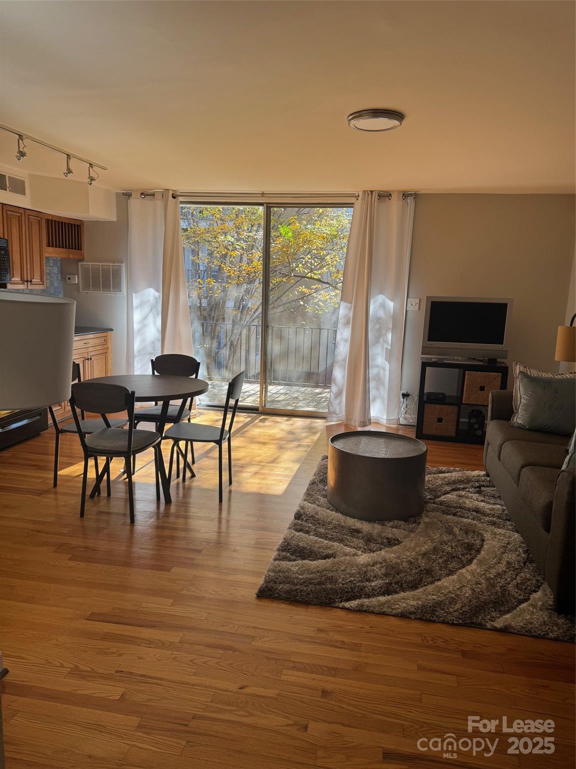 400 Queens Road Charlotte, NC 28207 - Photo 2 of 15 a living room with furniture a dining table and a floor to ceiling window