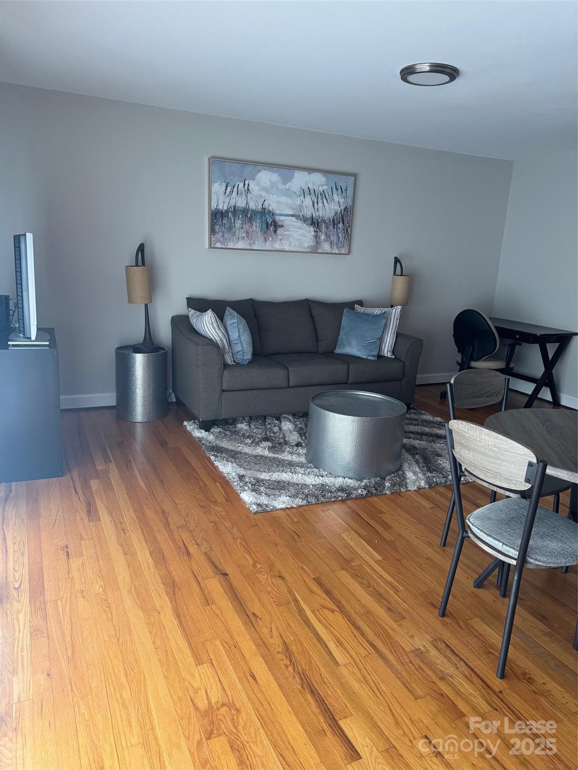 400 Queens Road Charlotte, NC 28207 - Photo 3 of 15 a living room with a couch and paintings on the wall