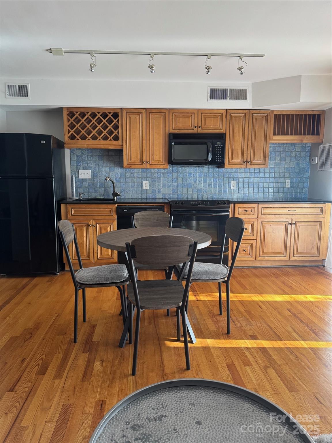 400 Queens Road Charlotte, NC 28207 - Photo 5 of 15 a kitchen with a table chairs and wooden floors