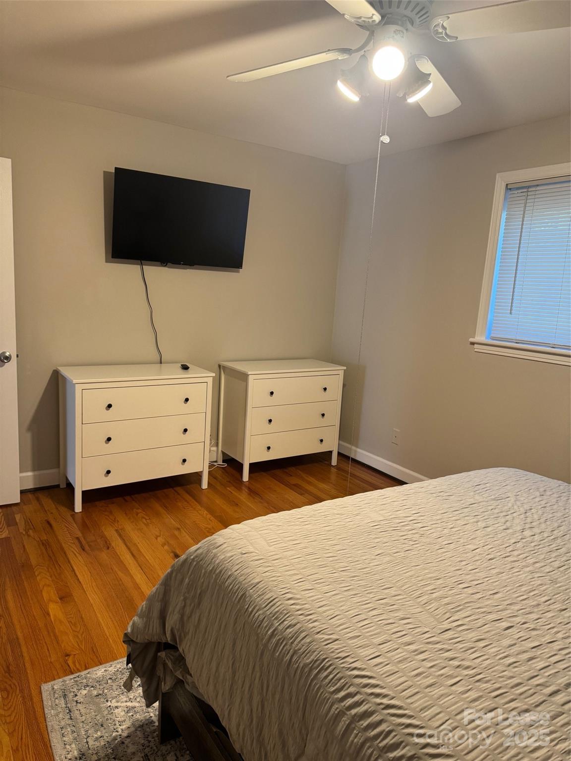 400 Queens Road Charlotte, NC 28207 - Photo 7 of 15 a bedroom with a bed and a flat tv screen on dresser