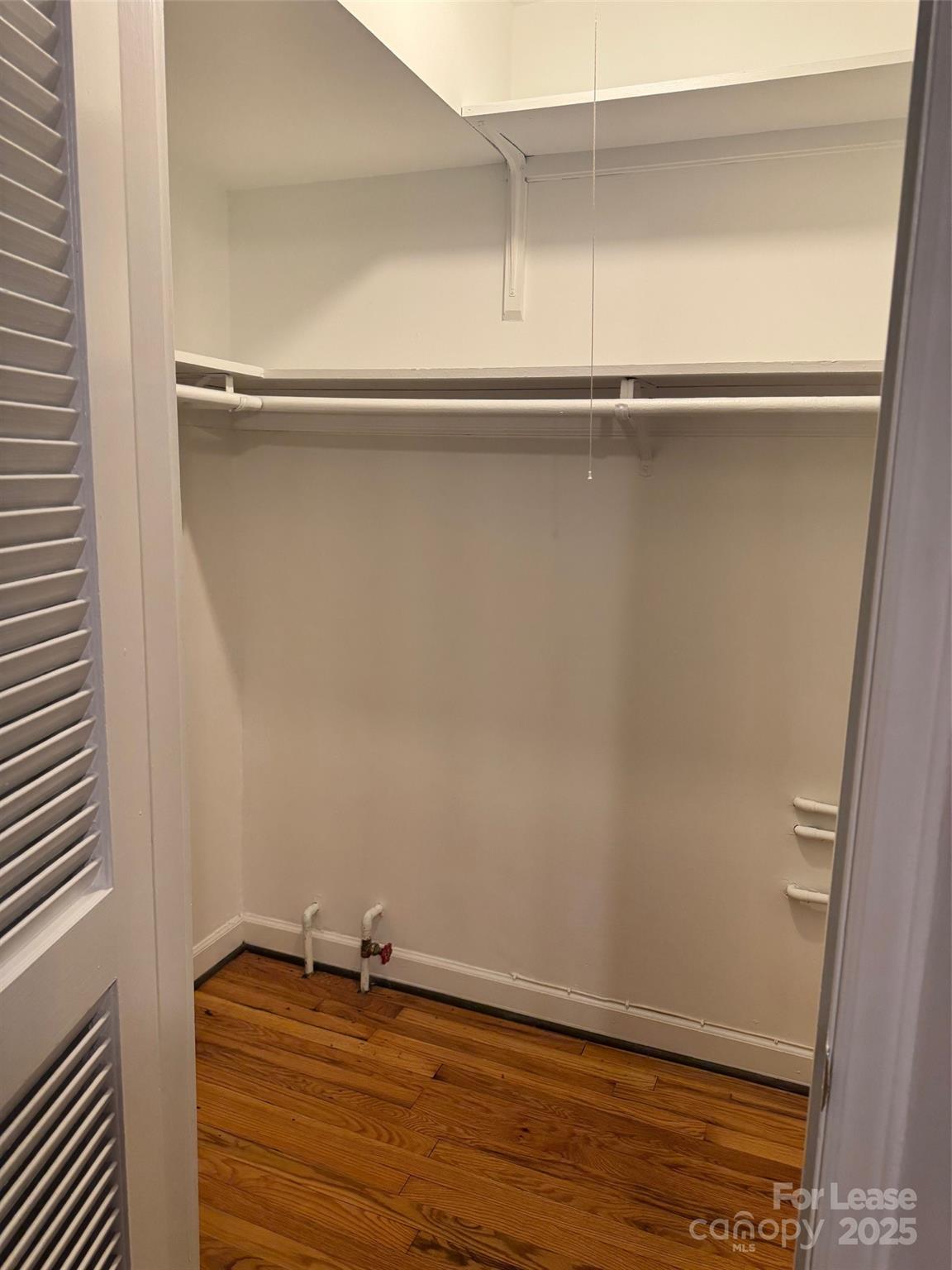 400 Queens Road Charlotte, NC 28207 - Photo 8 of 15 a view of an empty walk in closet