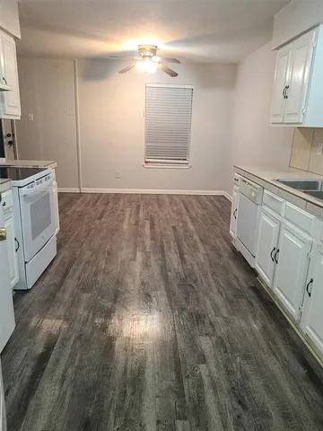 a view of cabinets and wooden floor