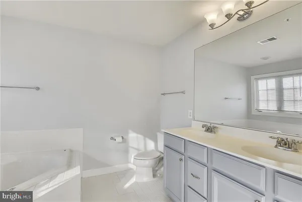 a bathroom with a sink a toilet and bathtub