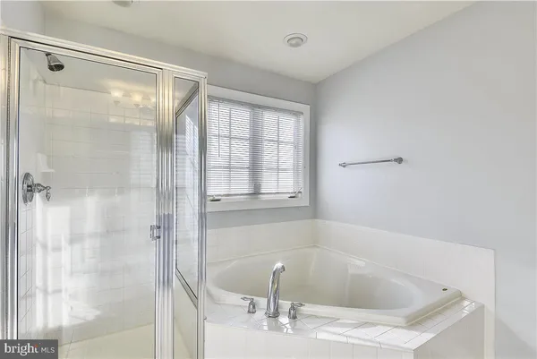 a bathroom with a bathtub and shower